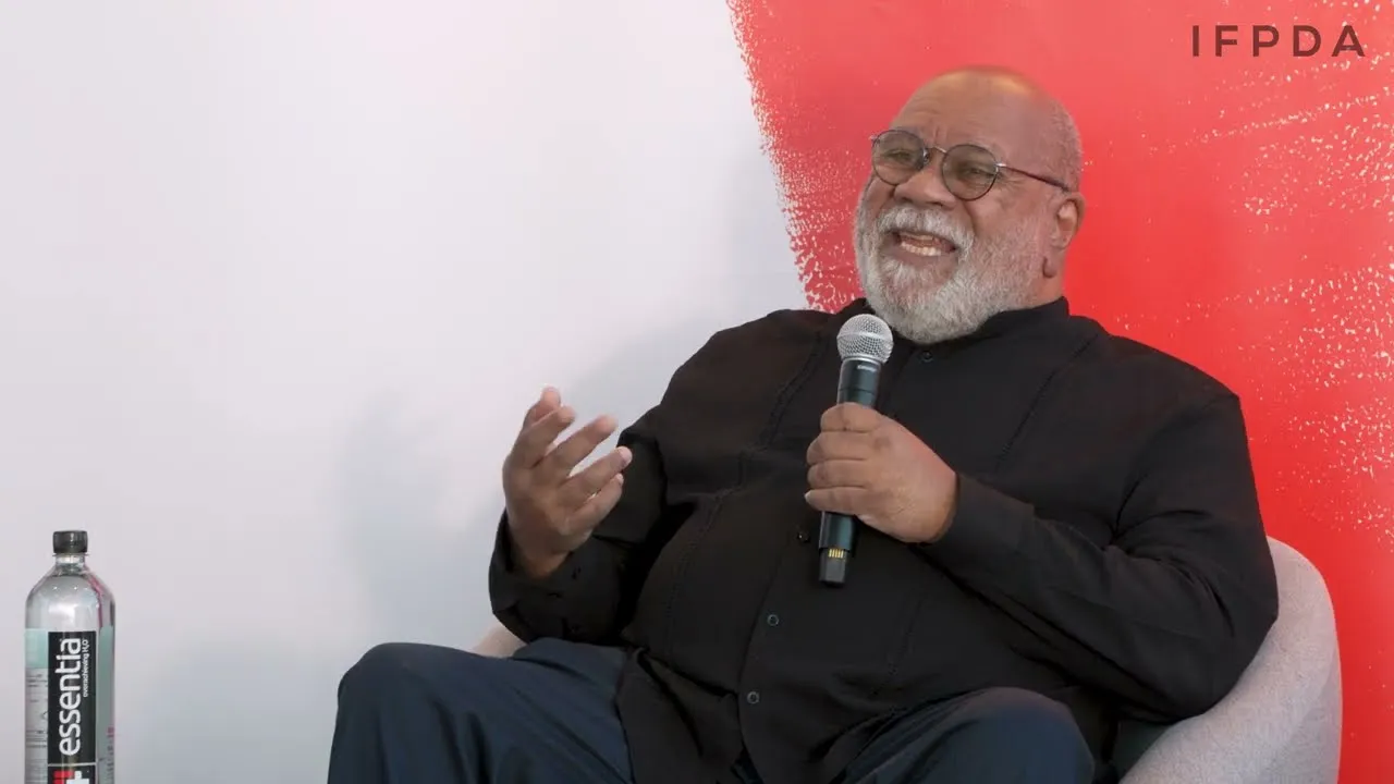 Title frame from the recording of “Colonialism is the Real AIDS: Artist Activist Juan Sanchez in Conversation with Deborah Cullen”