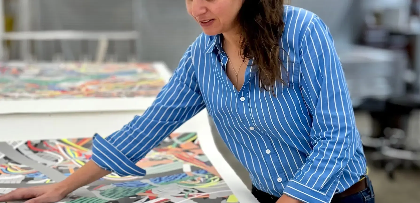 Analia Saban in the lithography studio at Gemini looking at proofs of E-Trash. Photo © 2026 Suzanne Felsen